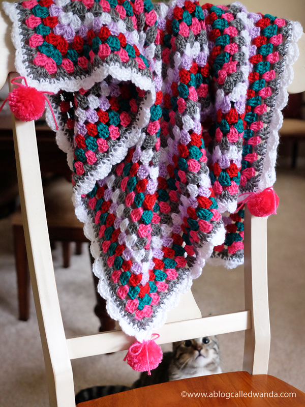 Beginner Crochet. Granny square baby blanket. Caron Simply Soft yarn. Shell stitch crochet border with pom poms