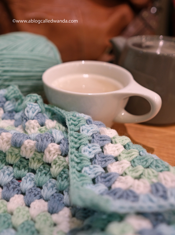Crochet Granny Square Blanket. Baby Blanket. Crochet ideas. Pastel colors. X border with pom poms. Wanda Guess, a blog called wanda, baby blanket, easy crochet blanket, baby boy gift