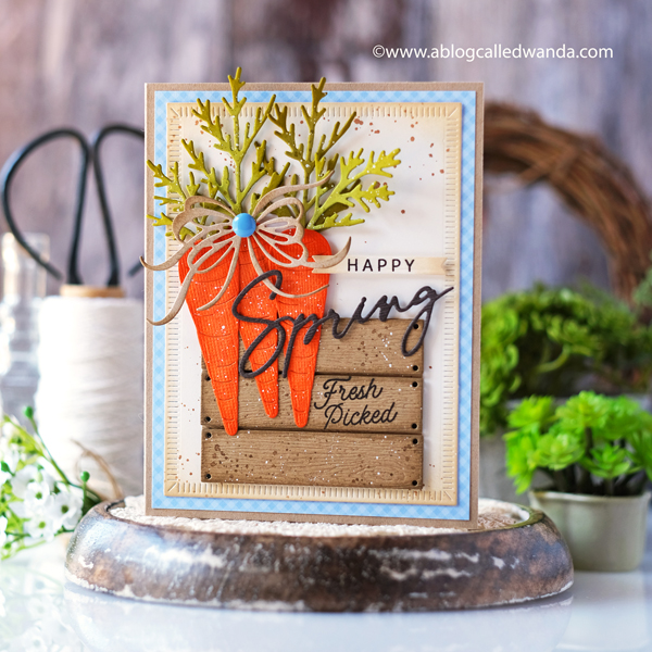 the greetery, the greetery new release, the greetery spring fever, the greetery easter, the greetery carrot die, the greetery bunny hop, the greetery wildflower mix dies, the greetery watering can, the greetery print shop, bow dies, watercolor, distress inks, empty grave stamp set, comforting commands, nordic circles, the greetery square dance dies and stencil, the greetery gingham, wanda guess, design team, a blog called wanda