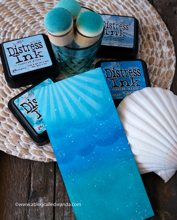 Tim Holtz Distress Ink blending, blended backgrounds, ocean background with distress inks. Stencil sun rays. Wanda Guess