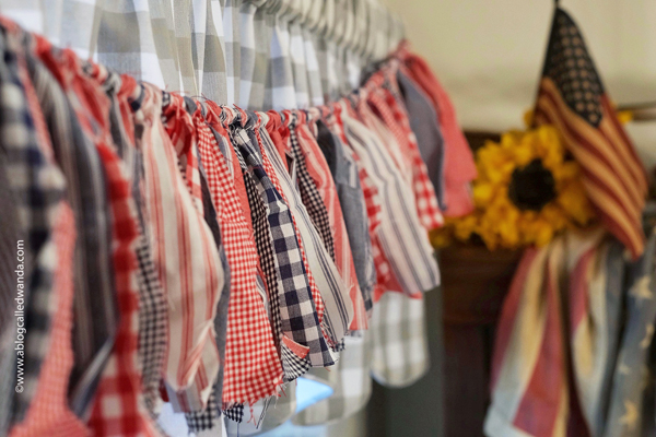 fabric garland, fabric strip garland, moda jelly roll, fabric ideas, home decor garland, make your own fabric garland, diy, gingham, 4th of july, halloween, shabby chic, wanda guess, a blog called wanda