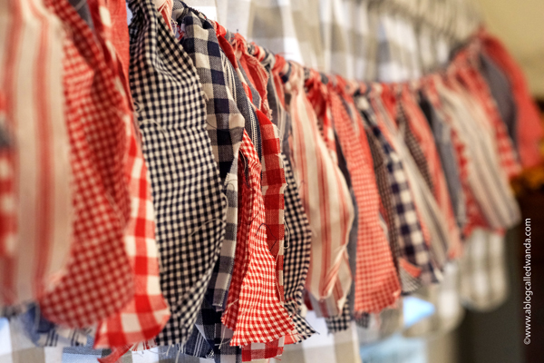 fabric garland, fabric strip garland, moda jelly roll, fabric ideas, home decor garland, make your own fabric garland, diy, gingham, 4th of july, halloween, shabby chic, wanda guess, a blog called wanda