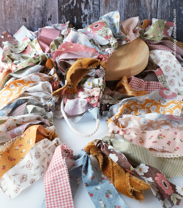 fabric garland, fabric strip garland, moda jelly roll, fabric ideas, home decor garland, make your own fabric garland, diy, gingham, 4th of july, halloween, shabby chic, wanda guess, a blog called wanda